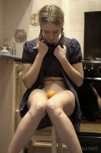 Hot blonde is playing with an orange today