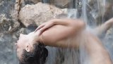 Skinny model is showing her amazing forms while being under a strong stream of cold water which massages her superb boobies while she is under it.