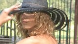 Watch how a smoking hot blondie reveals her skinny body with her small natural titties in the middle of a public park with green all over.