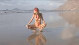Lovely brunette is demonstrating her fantastic solo skills on the beach. She is touching her naked body in the sea with great excitement.