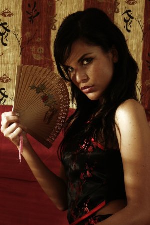 Dark-haired beauty undressing photo 1