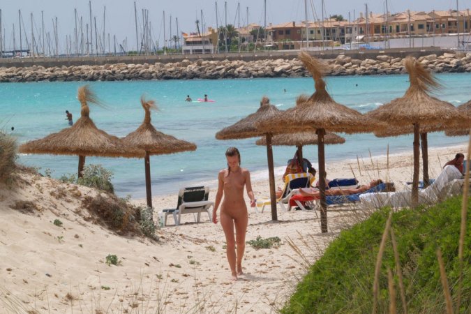 Young teeny babe loves posing nude on the beach photo 6