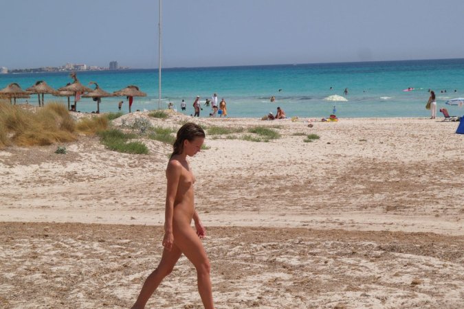 Young teeny babe loves posing nude on the beach photo 8