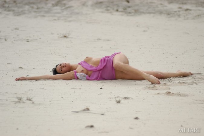 Dark-haired babe posing on the beach photo 16