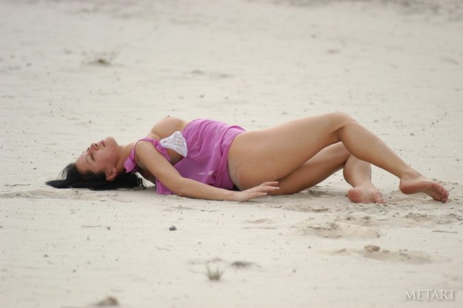 Dark-haired babe posing on the beach photo 20