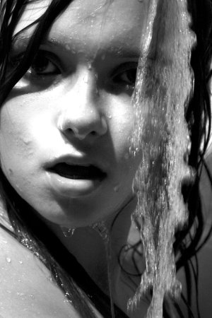 Black haired young model under the shower photo 8