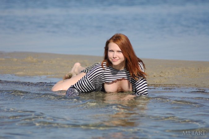 Stunning redhead playing in the water photo 14