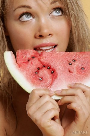 Pretty blonde is eating a watermelon photo 7