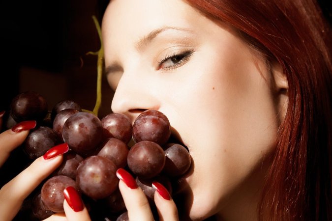 Sexy redhead enjoying her grapes photo 8
