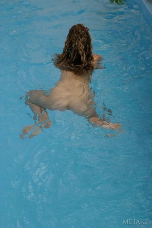 Curly cutie getting naked in the pool photo 4