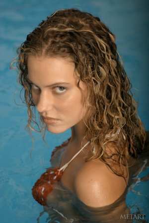 Curly cutie getting naked in the pool photo 12