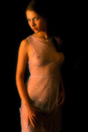 Serious looking chick is undressing photo 9