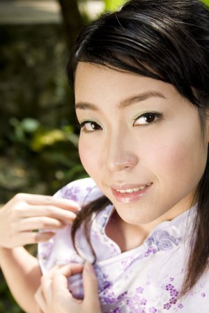 A kinky Asian chick is doing poses in the garden photo 1