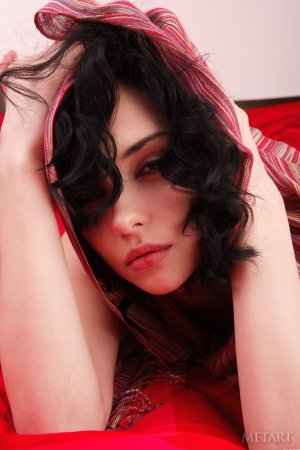Sensual dark-haired babe on red sheets photo 4