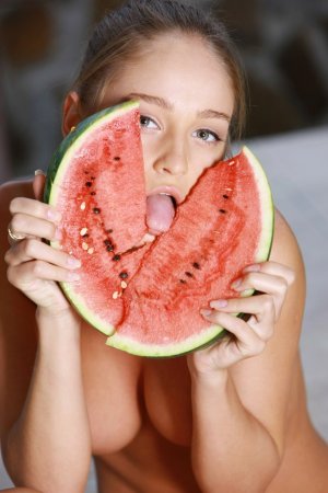 A busty woman puts some melons on her melons photo 9