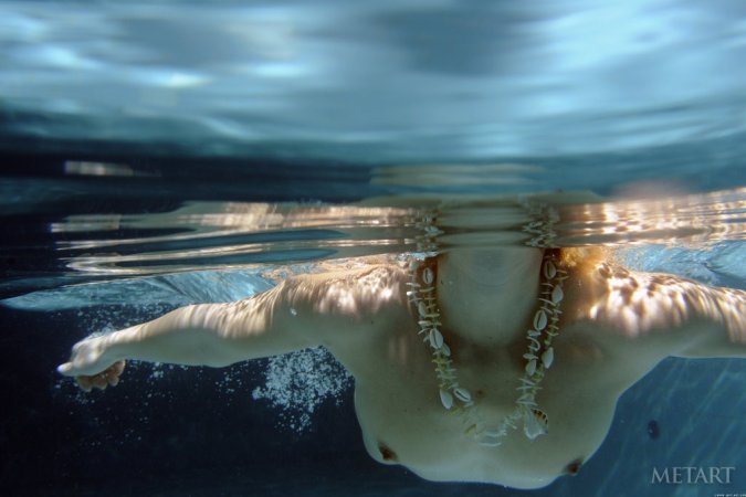 A redhead is dipping in the swimming pool photo 6