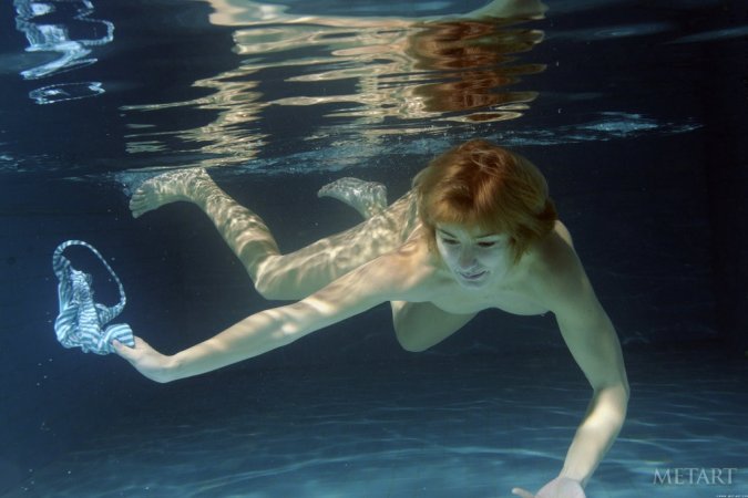 A redhead is dipping in the swimming pool photo 8