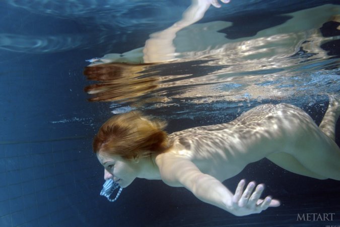 A redhead is dipping in the swimming pool photo 10