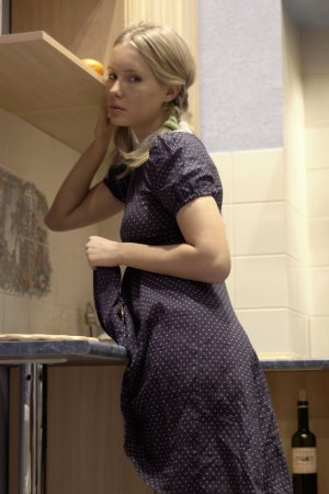 Blonde teen with pigtails posing in her kitchen photo 1