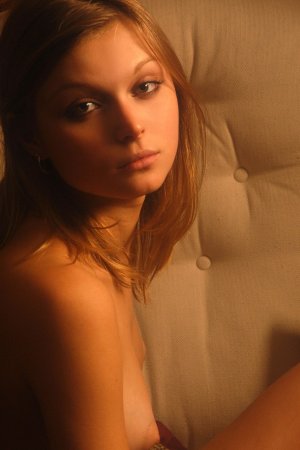 Brunette gets naked on an armchair photo 1