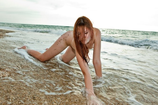 Splendid model resting her uncovered ass on beach sand photo 15