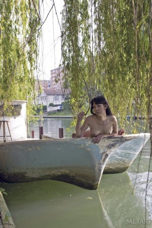 Cute chick is naked by the river photo 7
