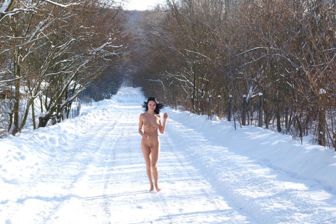 Jovial female strips outdoor during winter to pose photo 1