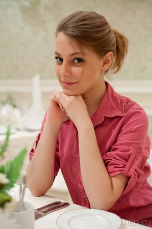 A curly brunette poses on the bed sheets photo 5