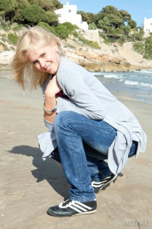 Blonde sits her ass down on a wooden floor photo 18