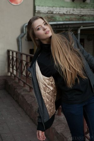 A tall blonde woman walks around the town photo 2