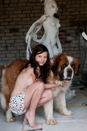 Tiny babe is playing with her dog photo 1
