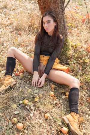 Slim cutie bares pussy and ass under the tree photo 5