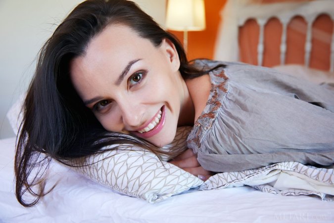 Dark-haired hottie gets a solo satisfaction in bed photo 9