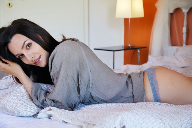 Dark-haired hottie gets a solo satisfaction in bed photo 18