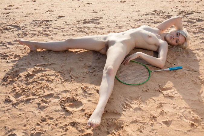 Hottie plays naked badminton on the beach photo 6
