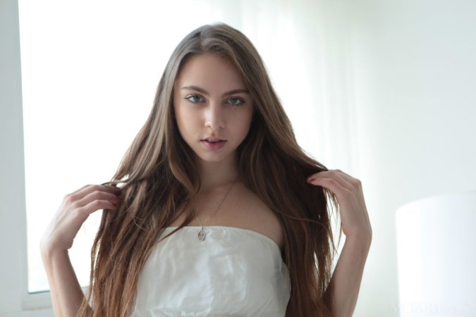 Naked cutie relaxes under warm sun photo 2