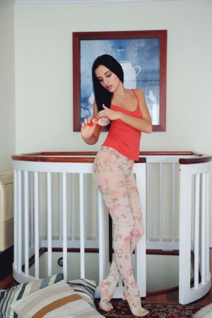 Dark-haired cutie spreads legs on a landing photo 1