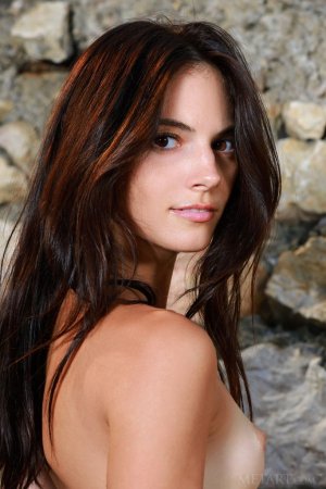 Dark-haired chick poses totally naked outdoors photo 18