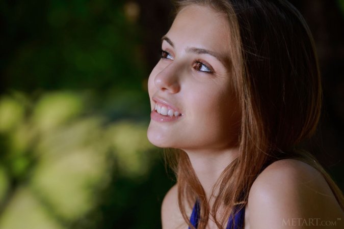 Slim cutie caresses herself on a tree photo 2