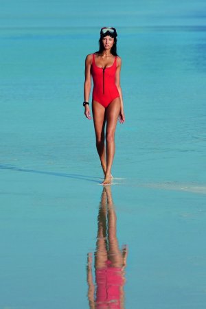 Tanned hottie works out on the beach and in sea photo 1