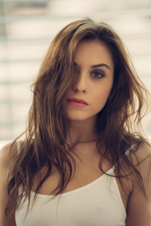 Bored cutie performs striptease before masturbation photo 13