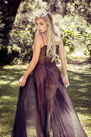 Busty blonde poses in a tight corset photo 12